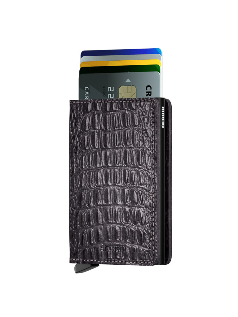 The Secrid Slimwallet Nile, a black wallet with crocodile texture, displays several colorful credit cards partially visible and stacked inside, set against a white background.