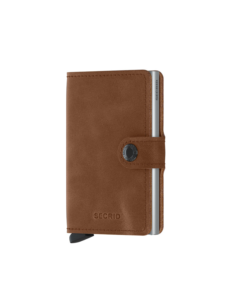 The Secrid Miniwallet Vintage Leather features a brown vintage leather design, snap button closure, silver aluminum edges, RFID protection, a black card-access tab, and embossed “SECRID” branding on the front.