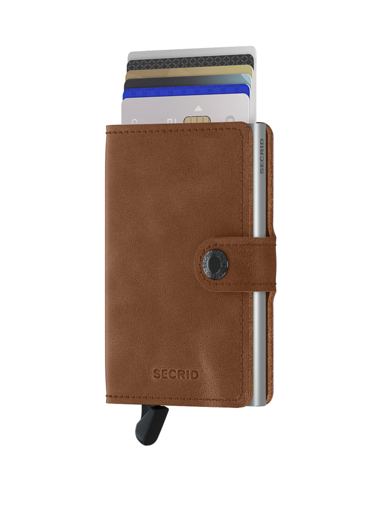 The Secrid Miniwallet Vintage Leather is a brown RFID wallet with a button clasp, showing several cards at the top and a black lever at the bottom for easy access.