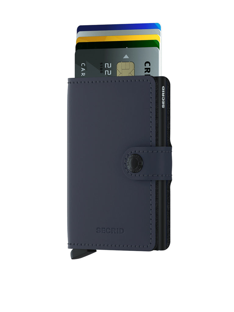 A Secrid Miniwallet Matte Finish Leather in dark blue is open, showing colorful cards in its slots on a white background—a compact, stylish wallet with a snap closure and built-in RFID protection.