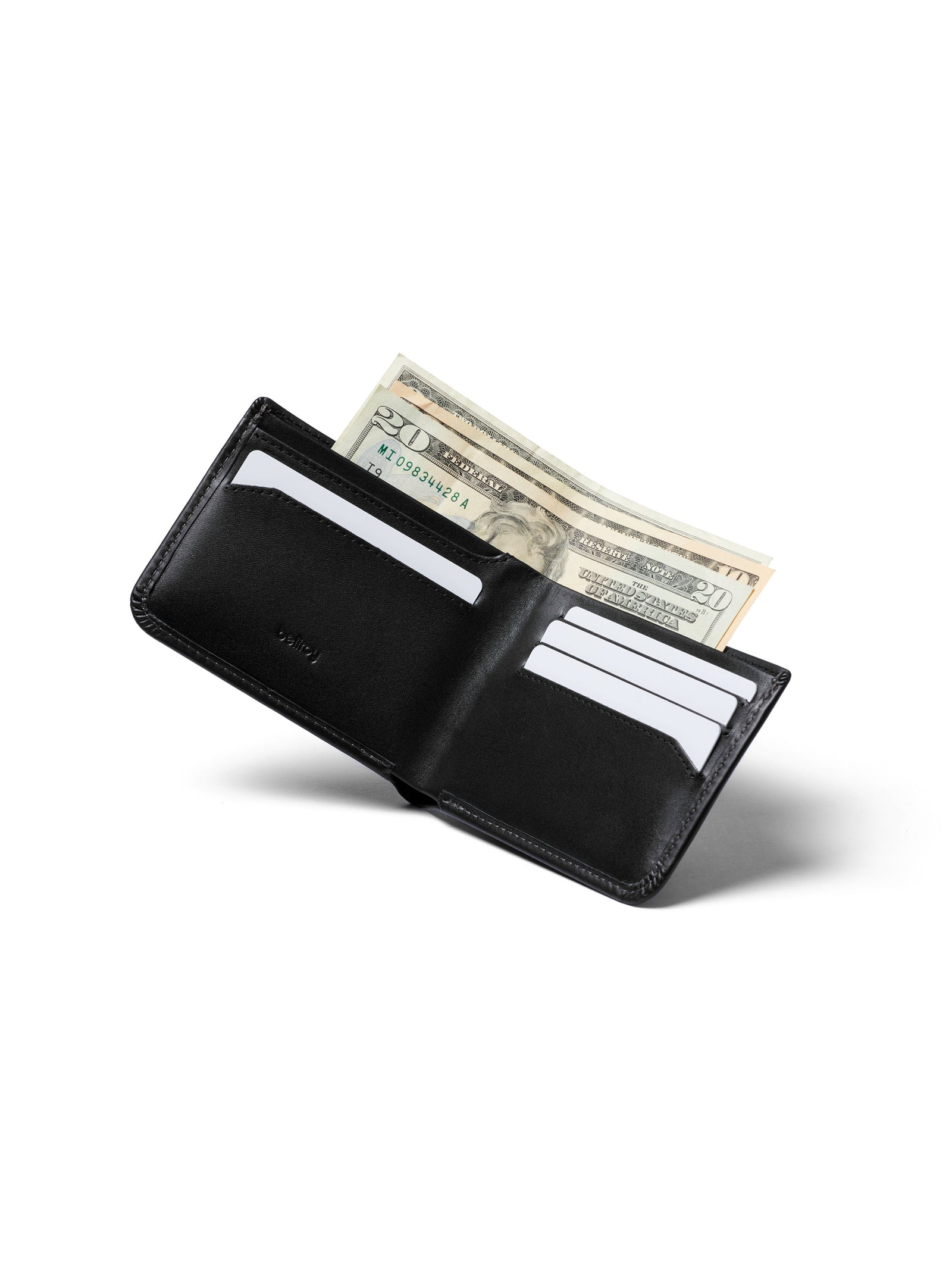 The Bellroy Hide and Seek Low Wallet, crafted from eco-tanned black leather, is open against a plain white background, displaying several credit cards in its slots and cash at the top. It features RFID protection for added security.