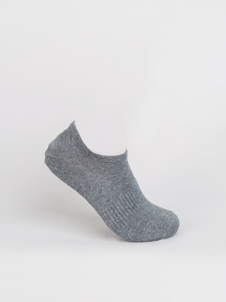 A gray No Show Ribbed Sock by ID Menswear, crafted from breathable fabric with a ribbed texture, stands upright against a plain white background, showcasing its minimalist design.