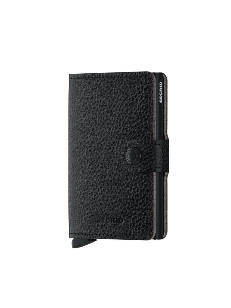 The Secrid Miniwallet Vegetable Tanned Leather is a black textured wallet with a button clasp, embossed Secrid logo, and built-in RFID protection, shown partially open to reveal metal card edges.