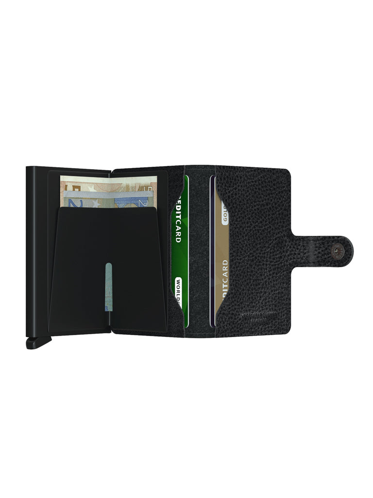 The Secrid Miniwallet Vegetable Tanned Leather is a black wallet with RFID protection, card slots, a section for bills, a snap-button closure, and is crafted from premium vegetable-tanned leather.