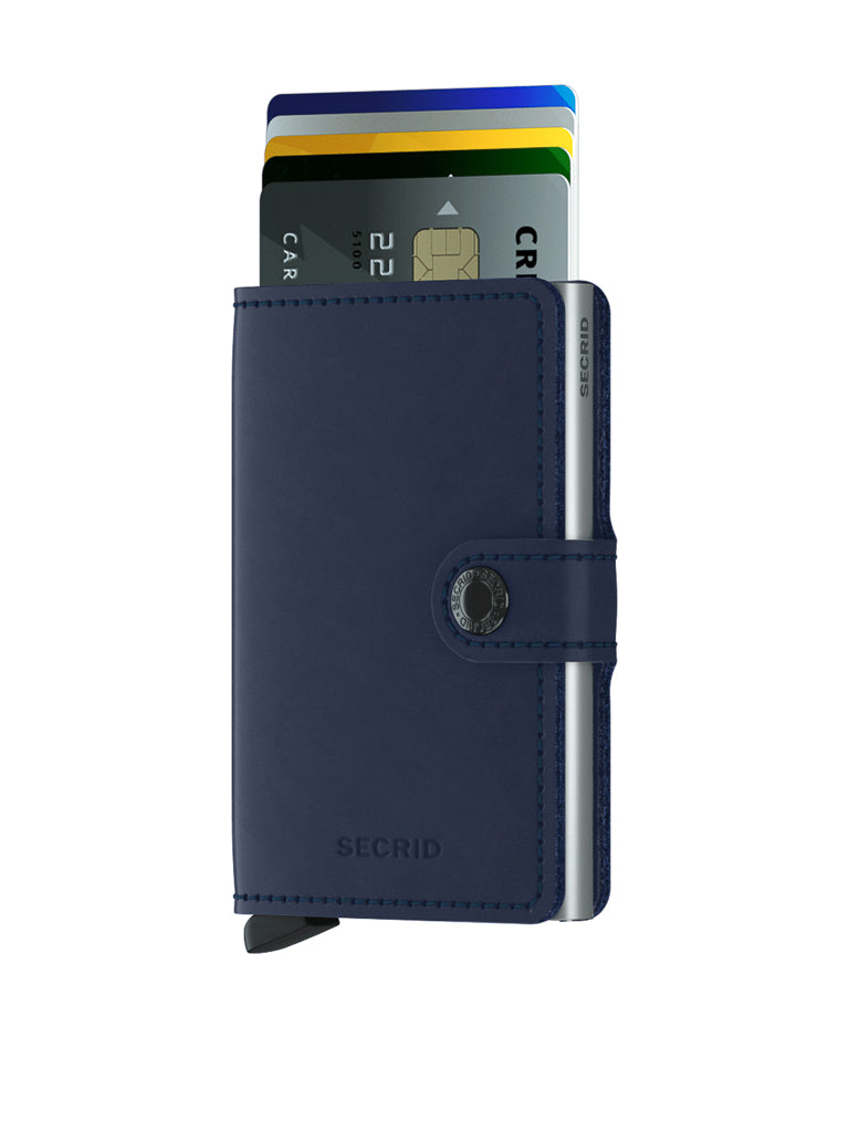 A Secrid Miniwallet Original by Secrid in navy blue with a button clasp is open, revealing multiple credit cards. This compact RFID-secure wallet is shown on a plain white background.