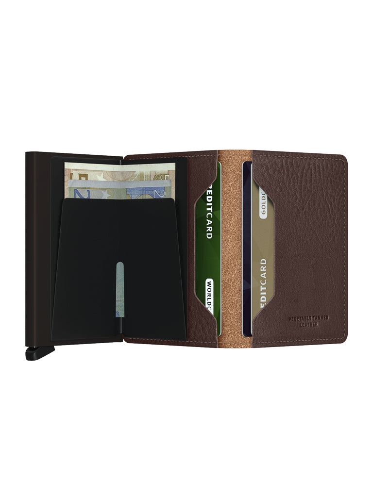 The Secrid Slimwallet Vegetable Tanned Leather is open, revealing euro banknotes and credit cards in slots. It boasts a sleek, modern black interior and features built-in RFID protection for secure and stylish storage.