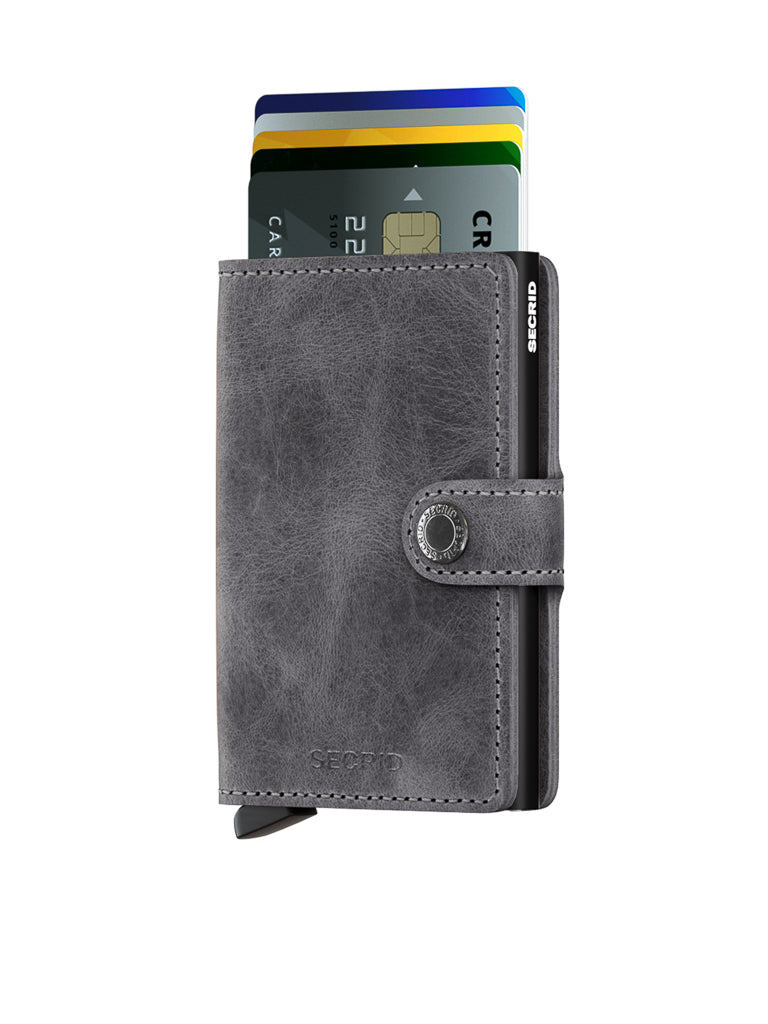 The Secrid Miniwallet Vintage Leather is a sleek grey wallet with a snap button closure, RFID protection, and space for several credit cards. Its modern design makes it perfect for everyday use.
