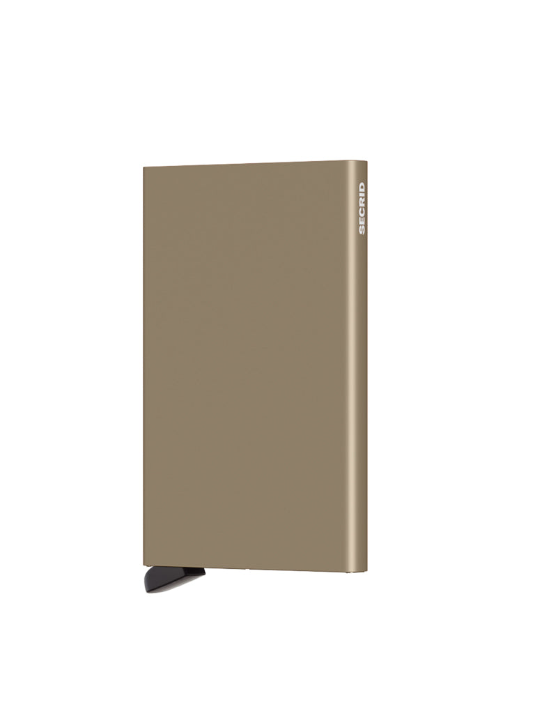A slim, rectangular, gold-colored Cardprotector Minimal Wallet by Secrid stands upright on a small black base, with the brand name written vertically on its side, resembling a minimal wallet against a plain white background.