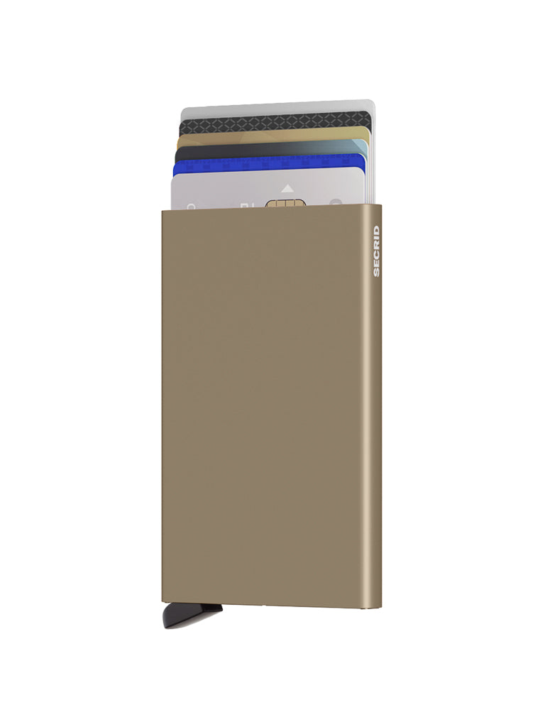 The Secrid Cardprotector Minimal Wallet in metallic gold stands upright against a white background, holding several credit cards that are partially visible at the top. A small black lever at the bottom adds style and security.