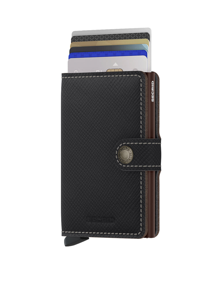 The Secrid Miniwallet Saffiano Leather is a black wallet with white stitching, RFID protection, and a textured finish. Featuring a snap button closure, it securely holds several credit cards that are partially visible at the top.