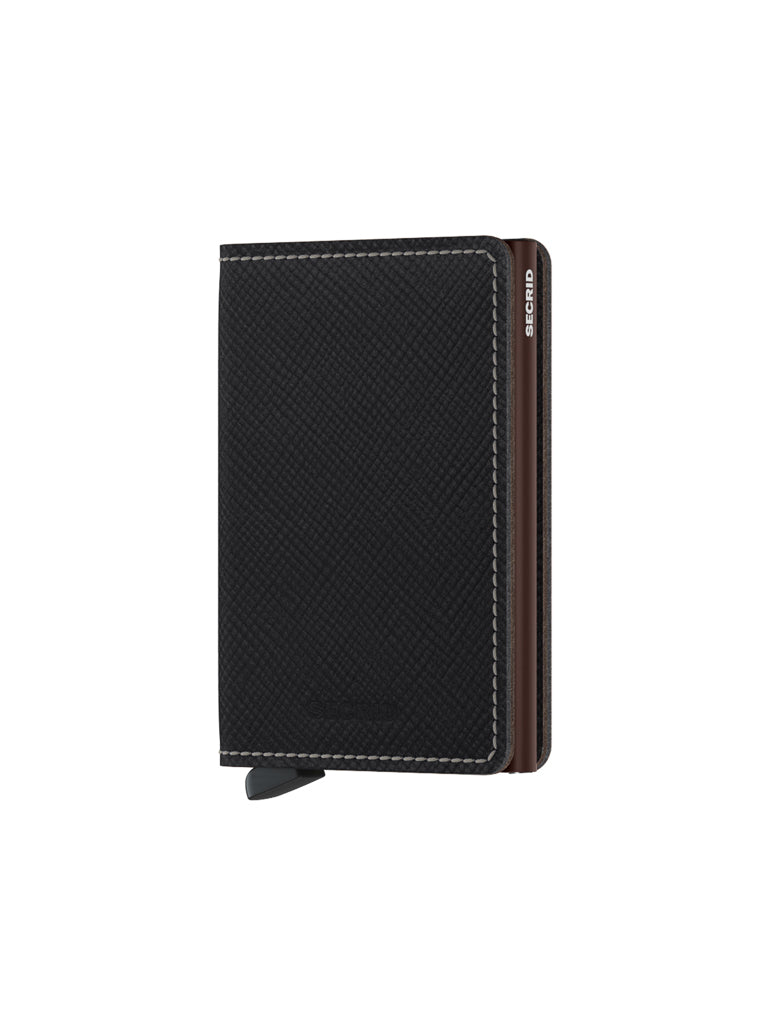 The Secrid Slimwallet Saffiano Leather features black textured leather with white stitching, a small tab, RFID protection, and a metal corner engraved with the Secrid logo, shown standing upright and closed.