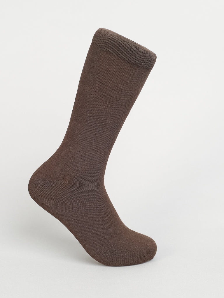 A Solid Color Combed Cotton Sock by ID Menswear stands upright on a white background. This brown knee-high sock boasts a ribbed cuff and smooth texture, ideal for everyday comfort.