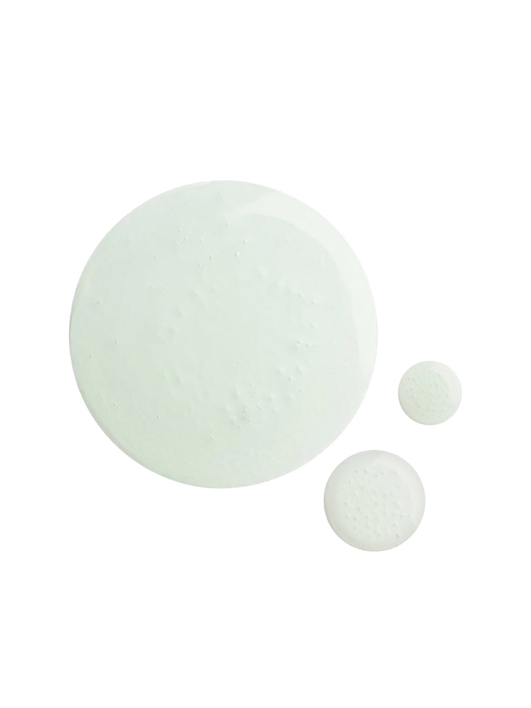 Three translucent, pale green drops of Baxter Shave Tonic serum on a white background suggest a cooling aftershave designed to prevent ingrown hairs.