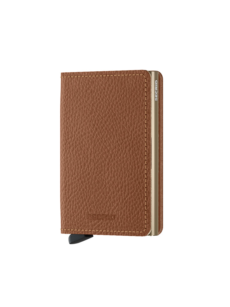 The Secrid Slimwallet Vegetable Tanned Leather is a slim, brown wallet with a gold metallic edge and a small black lever at the bottom, shown standing upright against a white background.