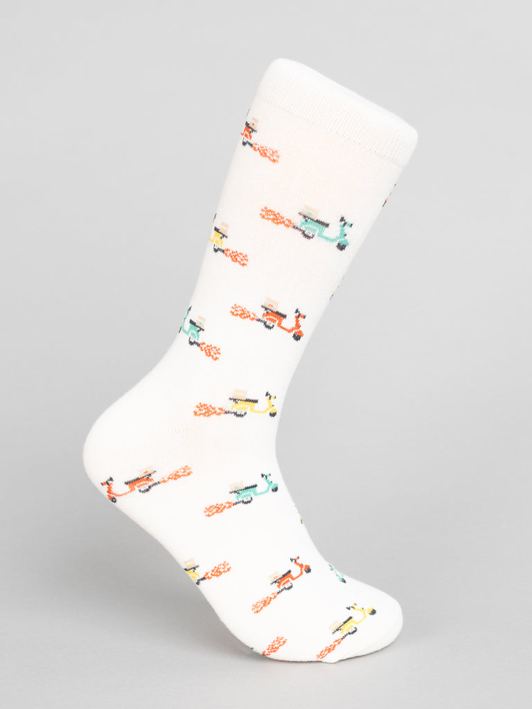 Introducing ID Menswears Blazing Scooter Graphic Socks: crafted from premium combed cotton, these white socks feature a vibrant pattern of red, green, yellow, and blue scooters on a gray background for breathable style and comfort.
