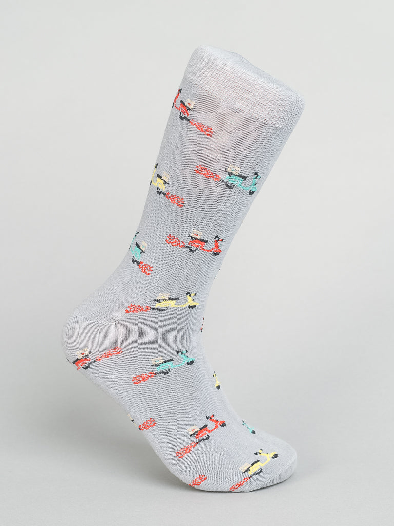 The Blazing Scooter Graphic Socks by ID Menswear are gray and crafted from breathable combed cotton. These socks feature small, colorful bicycles in red, yellow, blue, and green against a light background.