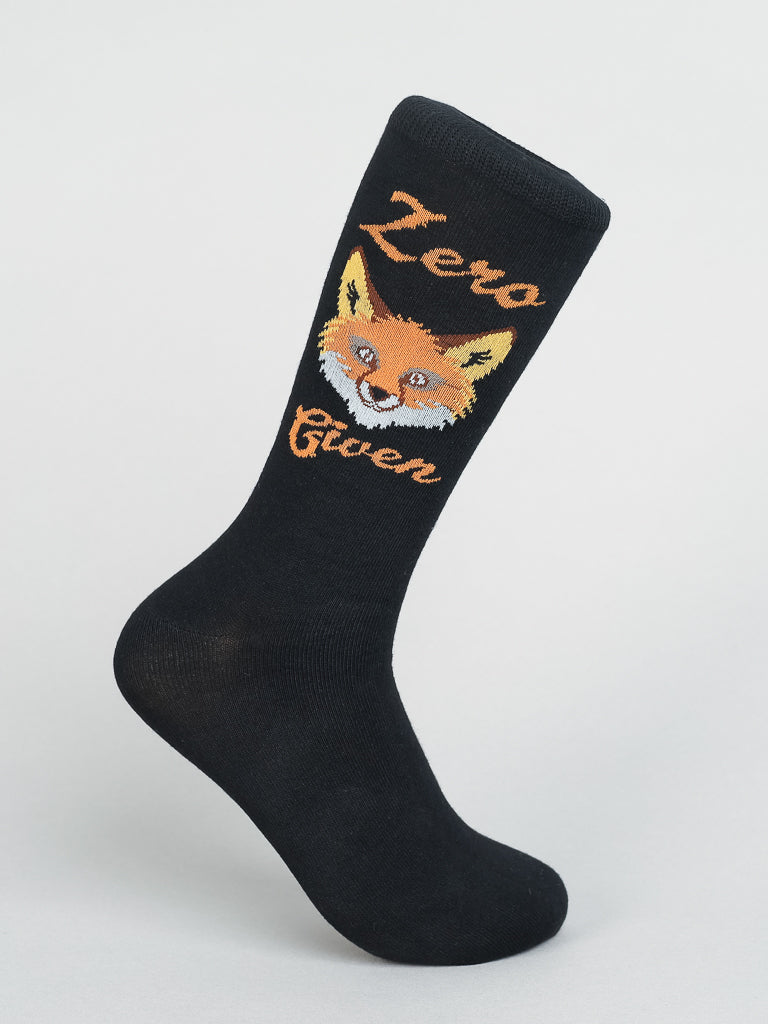 ID Menswears Zero Fox Given Graphic Socks feature a smiling cartoon fox on a black background with Zero Given in bold orange lettering, crafted from premium combed cotton.
