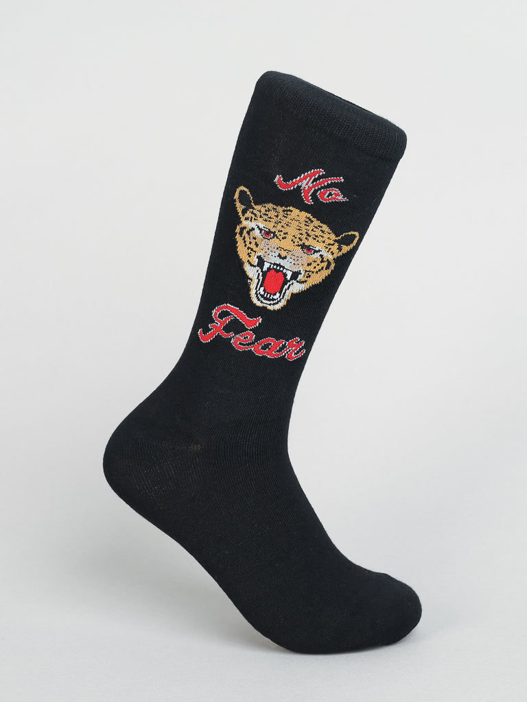 The black No Fear Graphic Sock by ID Menswear, made from premium combed cotton, features an embroidered roaring leopards head and No Fear in red cursive. Displayed upright on a neutral background, it offers unmatched comfort.