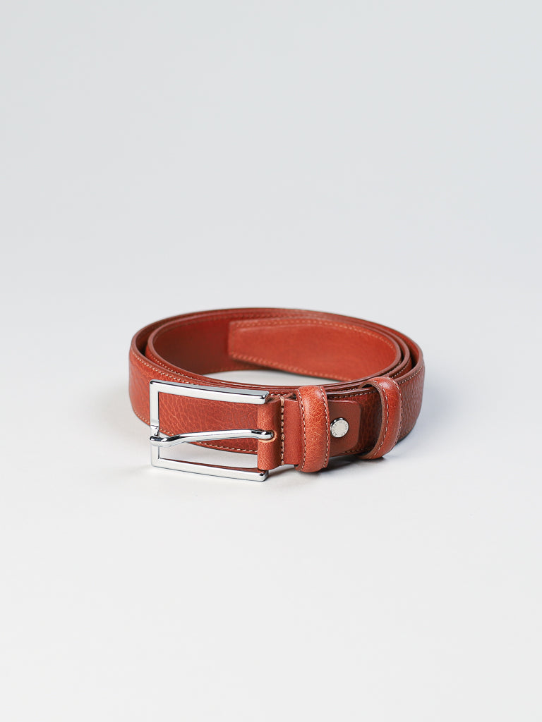 The ID Menswear 4061 Made in Italy Leather Belt, featuring a silver buckle and crafted from brown genuine leather, elegantly rests on a plain white background.