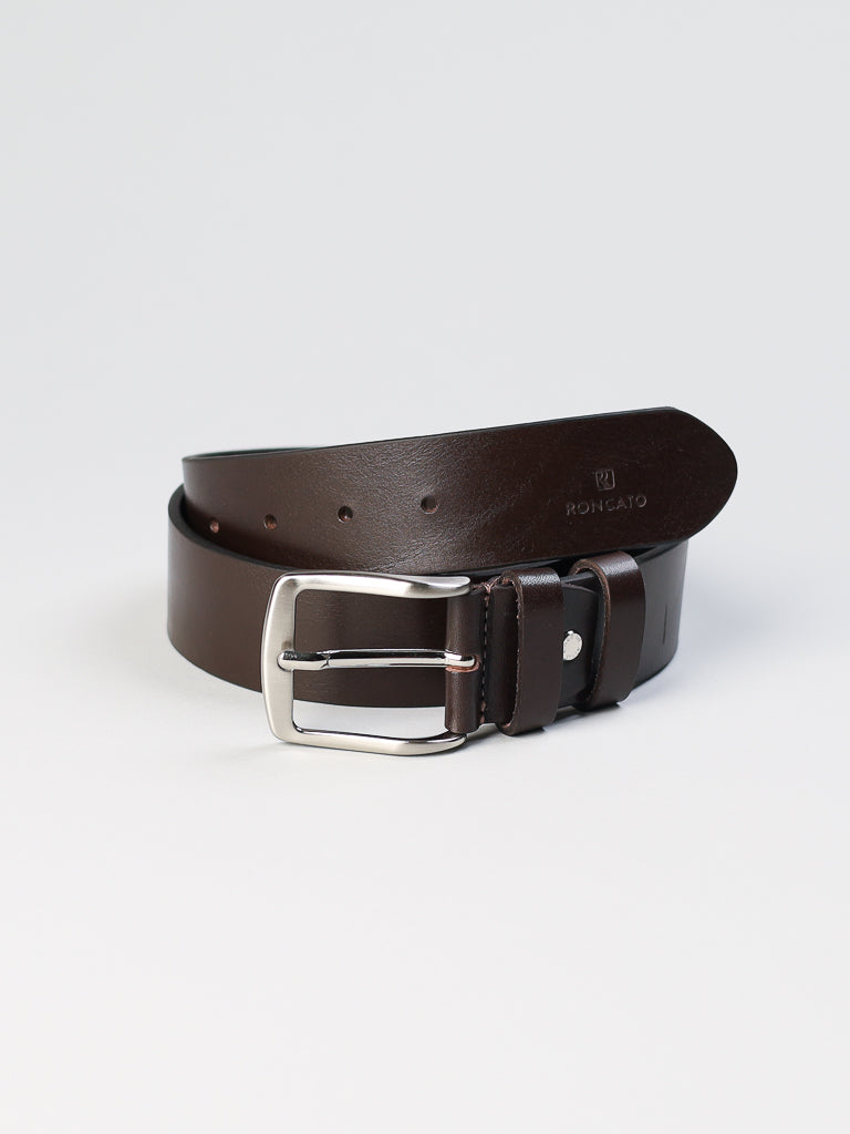 The Italian-made 4550 Leather Belt by ID Menswear, featuring a silver buckle and subtly embossed brand name, is coiled on a white surface.