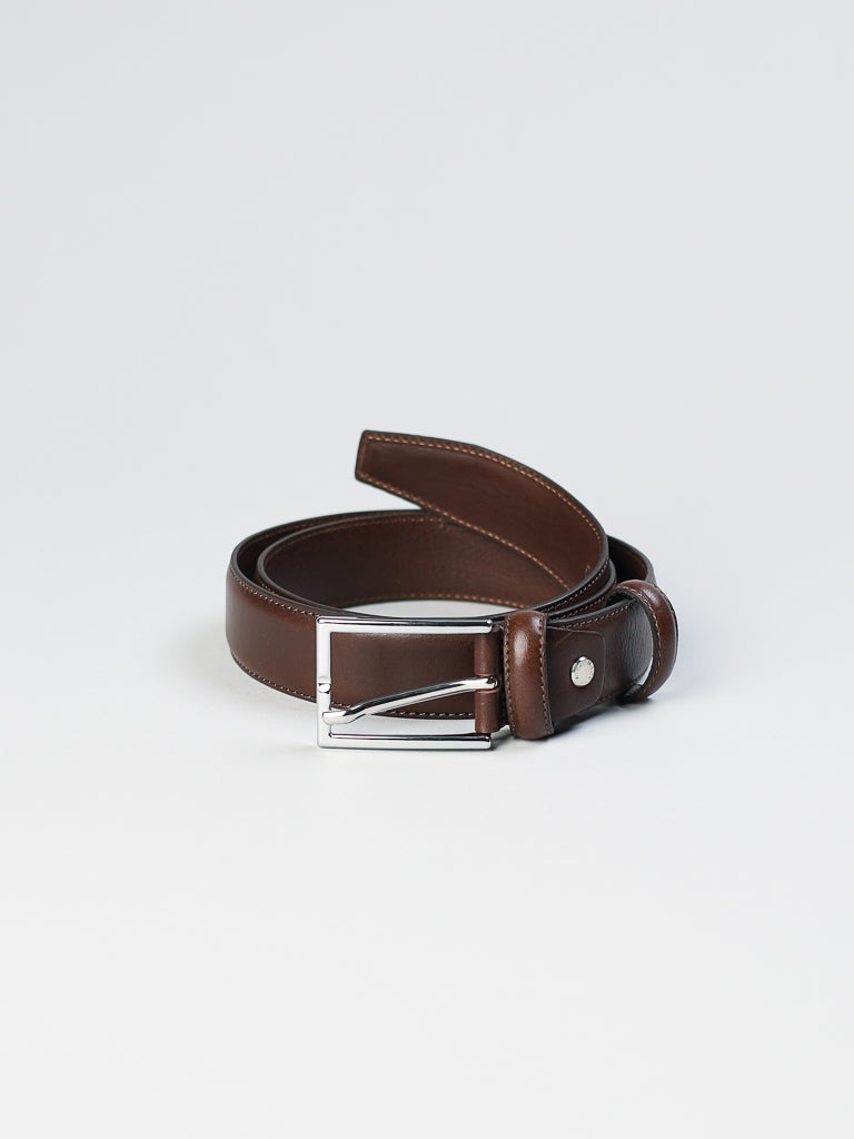 The 4061 Made in Italy Leather Belt by ID Menswear, crafted from genuine coiled brown leather and featuring a silver rectangular buckle, is elegantly displayed against a plain white background.