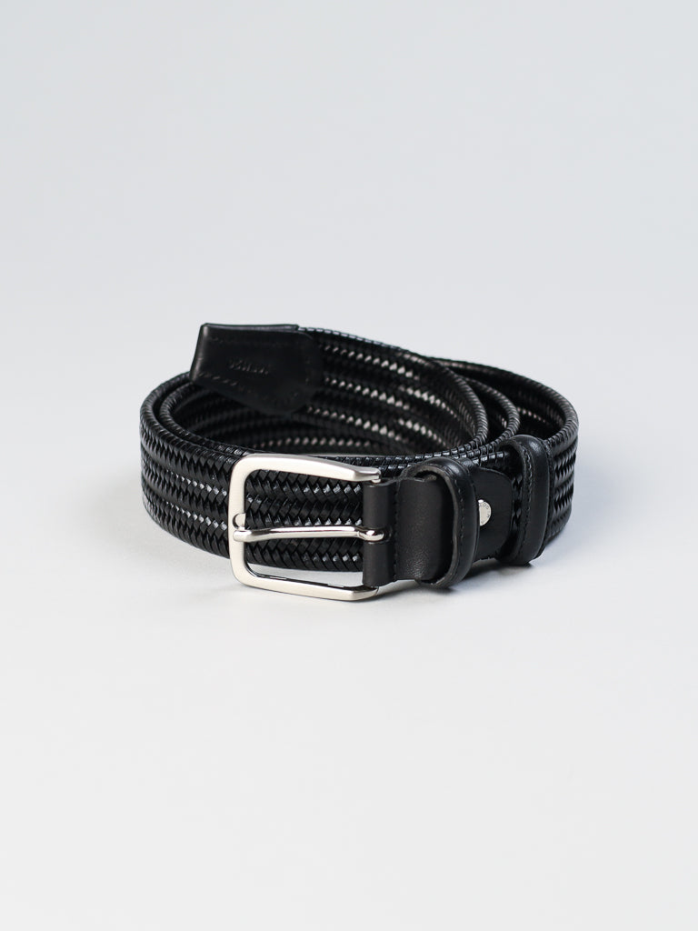 The 4553 Made in Italy Braided Leather Belt by ID Menswear, coiled on a white background, is a black genuine leather accessory with intricate weaving and a polished silver buckle, illustrating timeless elegance.