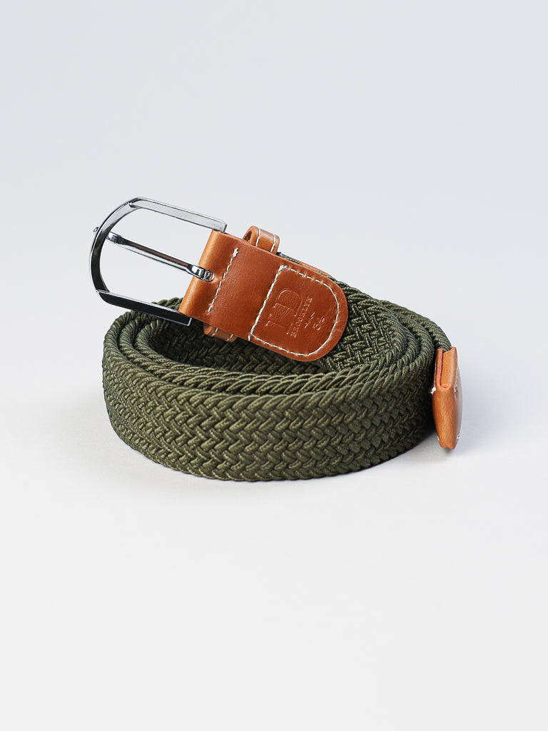 A green braided stretch belt with brown leather accents and a silver metal buckle from ID Menswear rests on a light gray background.