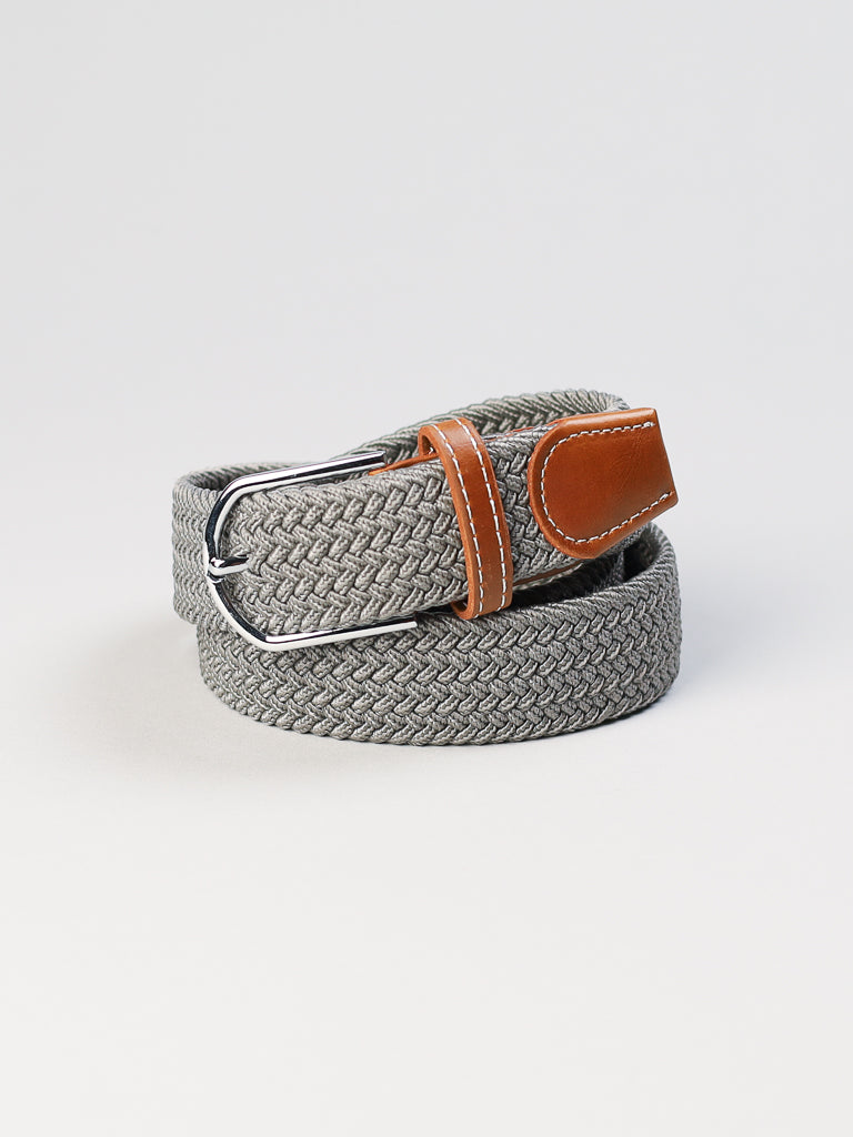 The ID Menswear ID Braided Stretch Woven Belt features a coiled design in grey with a polished metal buckle and brown leather end, set against a plain light background.