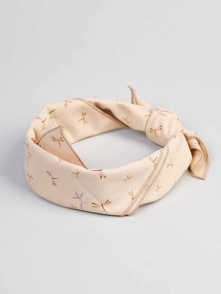 The Cream Dragonfly Bandana by ID Menswear is made from 100% cotton and showcases small, colorful dragonflies elegantly arranged in a circular pattern on a plain background.