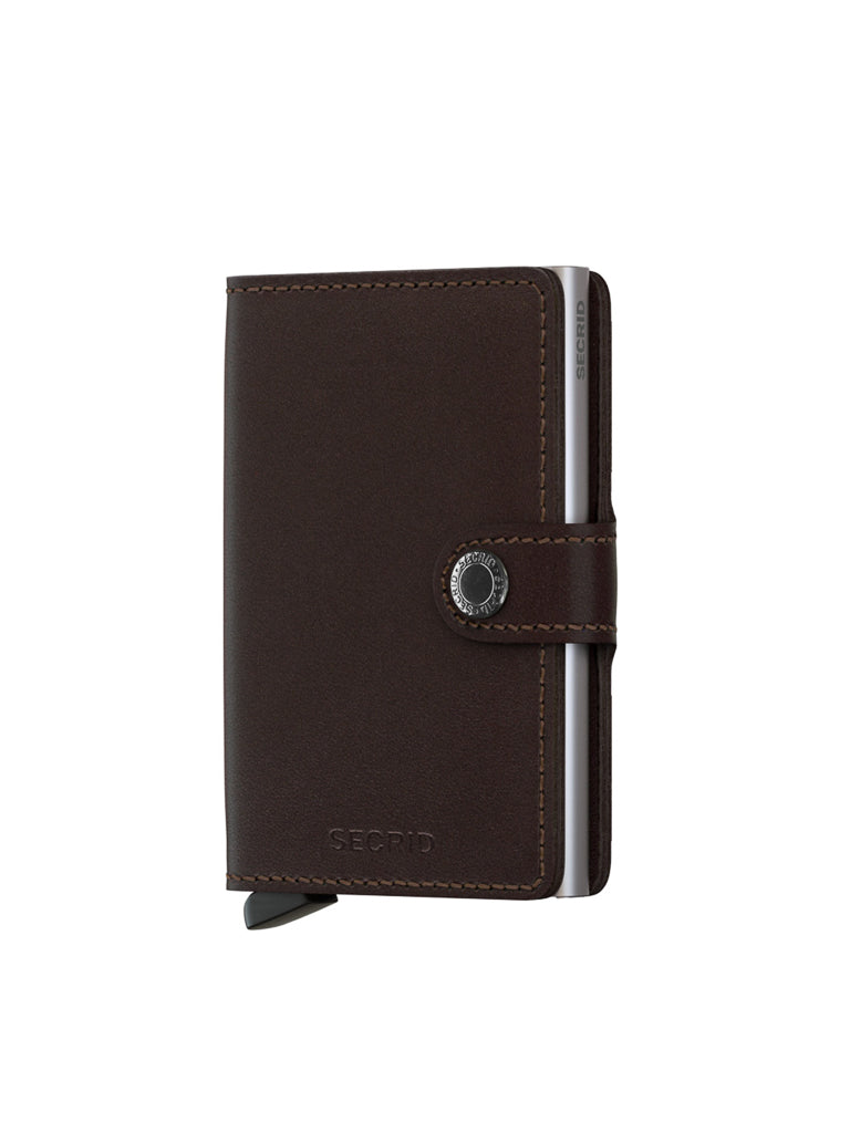 A Secrid Miniwallet Original by Secrid in brown leather, with a snap button closure, side card slot, and RFID protection, is displayed upright against a white background.