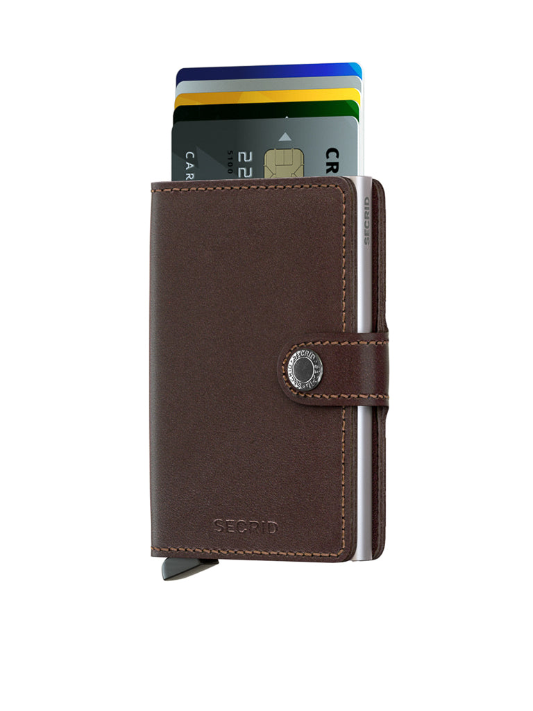 A Secrid Miniwallet Original by Secrid, shown in brown leather with a snap closure and RFID protection, holds several partly visible credit cards at the top, displayed on a white background.