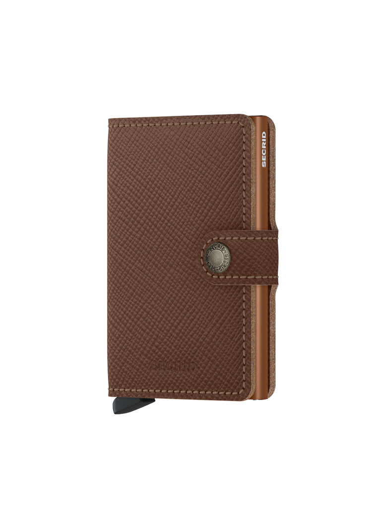 The Secrid Miniwallet Saffiano Leather is a brown textured wallet with RFID protection, snap closure, and a visible metallic card edge, shown against a white background.