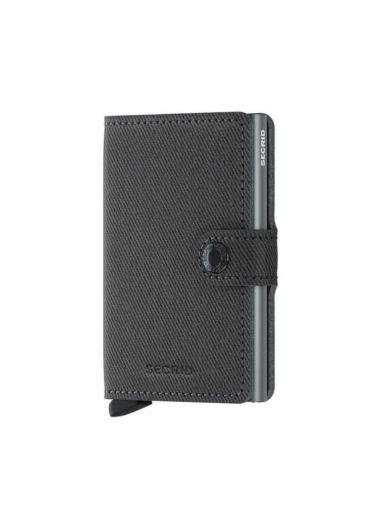 The Secrid Miniwallet Twist Twill Leather is a black textured wallet with RFID protection, snap button closure, visible metal edge, and features the Secrid brand name on the front and side.