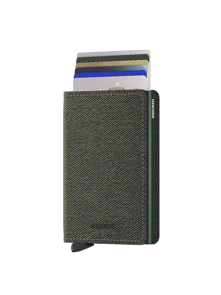 The Secrid Slimwallet Twist Twill Leather, in dark green with textured finish, stands upright and partially open, displaying neat, colorful cards. This slim leather wallet offers RFID protection and features a pull tab at the bottom.