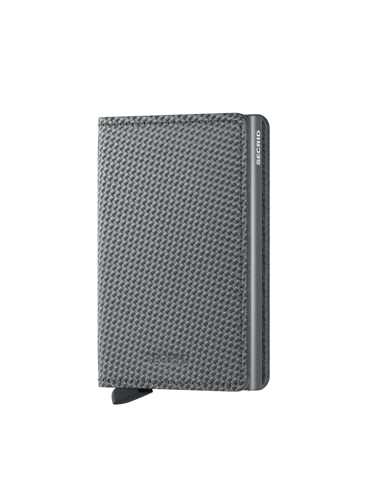 The Secrid Slimwallet Carbon Fibre Pattern Leather, featuring RFID protection, a metal trim, and a small black tab, stands upright against a white background with the SECRID logo visible on the metal edge.