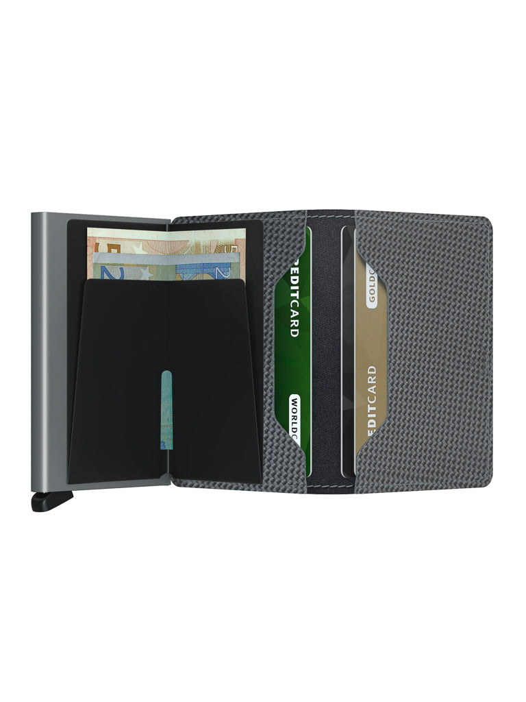 The Secrid Slimwallet Carbon Fibre Pattern Leather is a modern, open slim wallet with a textured gray exterior and RFID protection, shown with euro banknotes and credit cards organized in its slots against a white background.