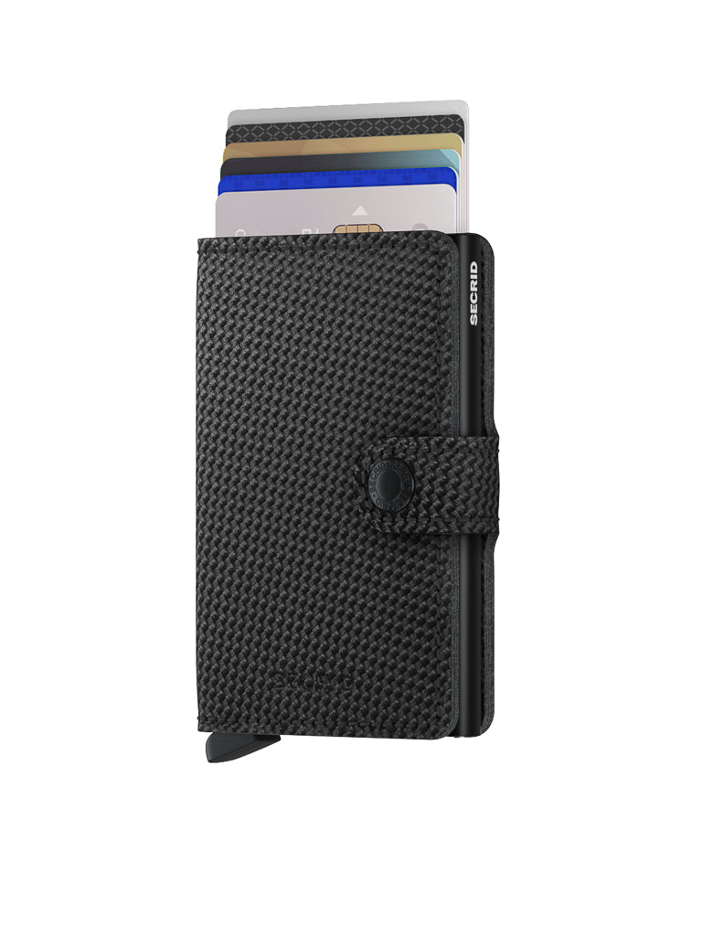The Secrid Miniwallet Carbon Weave Pattern Leather is a black textured compact wallet with RFID protection and a snap closure, shown upright with cards partially visible inside against a white background.