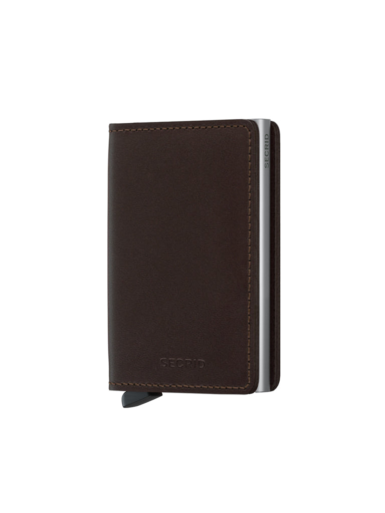 The Secrid Slimwallet Original, crafted from premium European leather with visible stitching and a small metal tab, stands upright on a white background. The front features a subtle Secrid emboss and built-in RFID protection.