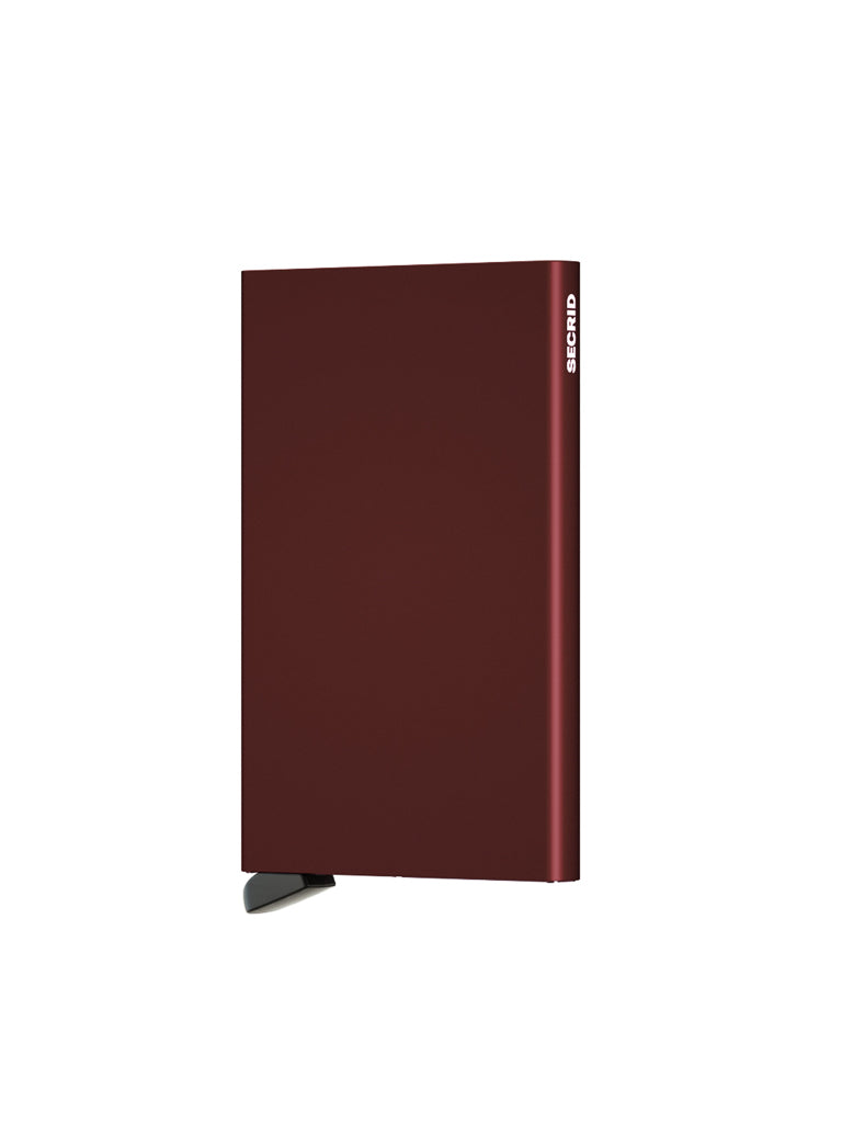 The Secrid Cardprotector Minimal Wallet is a slim, rectangular, dark red wallet with a small black lever for RFID protection. "SECRID" appears in white on the top right; the background is plain white.