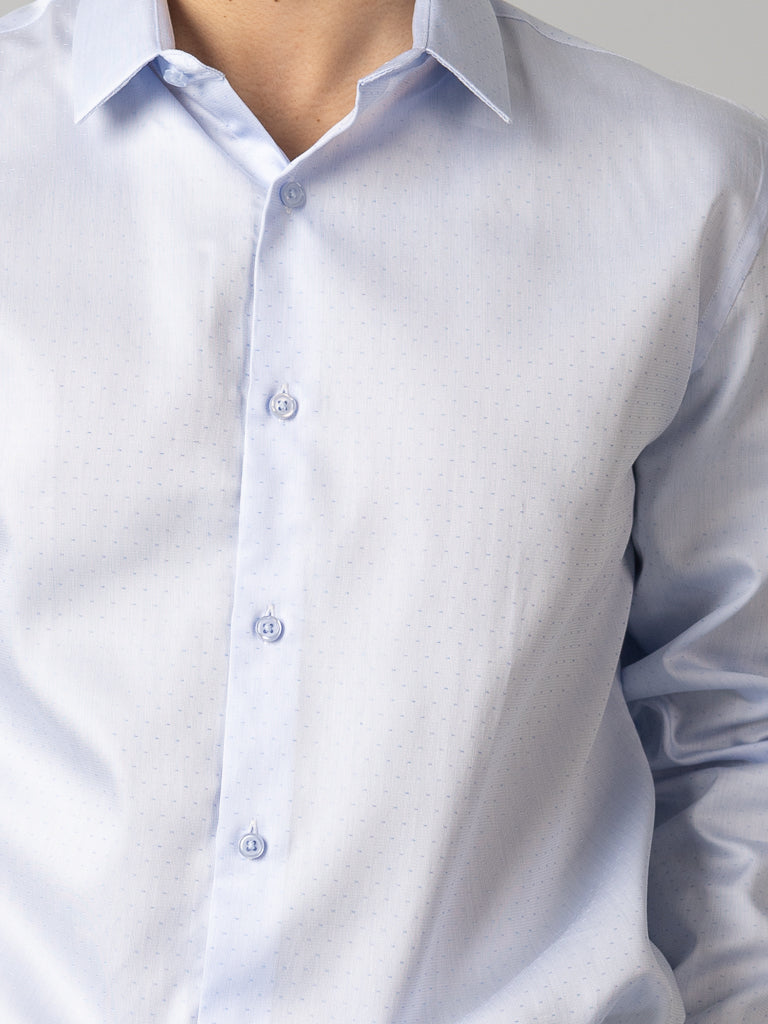 A person wears a slim fit ID Menswear Cotton Dress Shirt in light blue with subtle vertical stripes. The image focuses on the upper torso and neck, excluding the face.