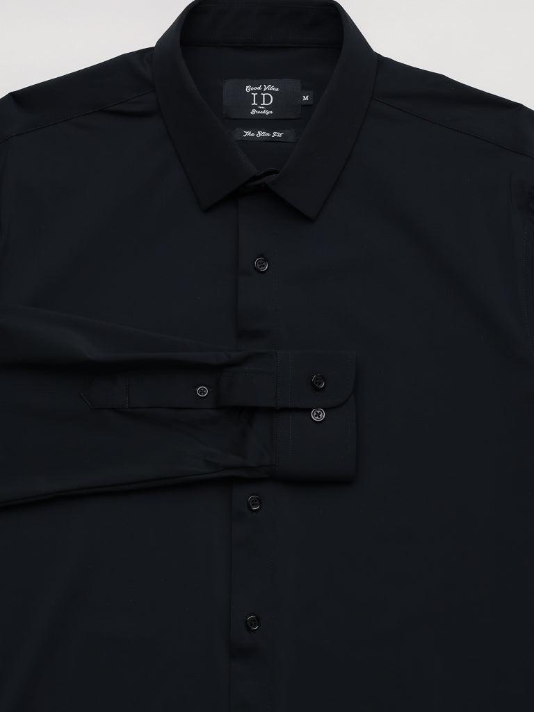 The Axel 4-Way Stretch Dress Shirt by ID Menswear is a black slim-fit, button-up design with a collar, featuring folded sleeves and fastened buttons for a sleek look and optimal comfort.
