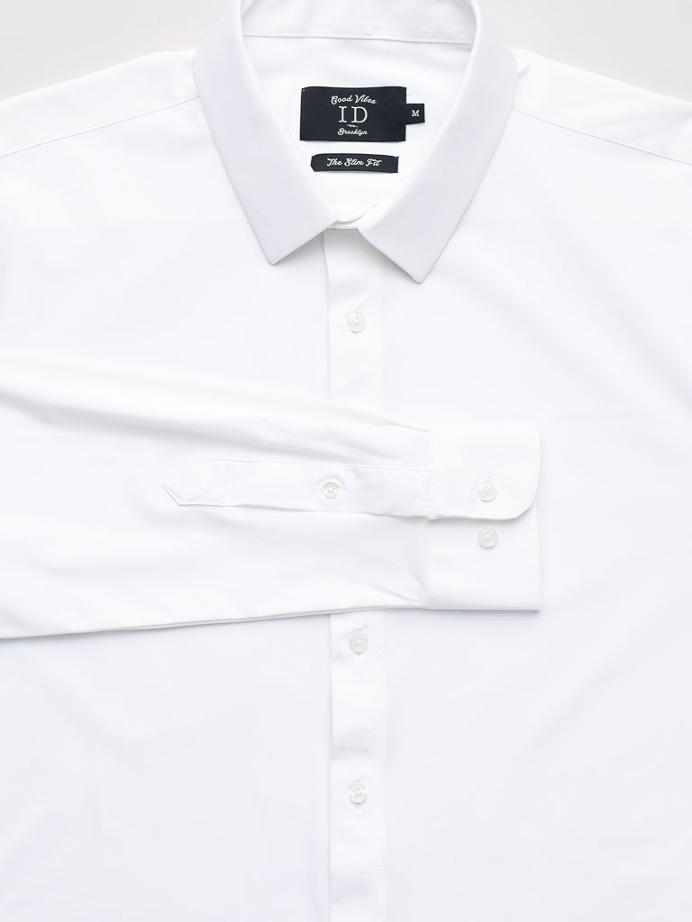 The Axel 4-Way Stretch Dress Shirt by ID Menswear is a neatly folded, white, slim-fit shirt featuring long sleeves, a classic button-down front, buttoned cuffs, and a brand label with size on the inside collar for comfortable wear.