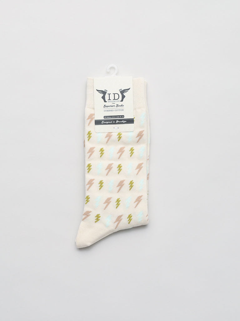 The Lightening Graphic Sock by ID Menswear is cream-colored with yellow and brown lightning bolts, crafted from premium combed cotton. Shown flat on a white background with a top label, it fits men’s shoe sizes 8-12.