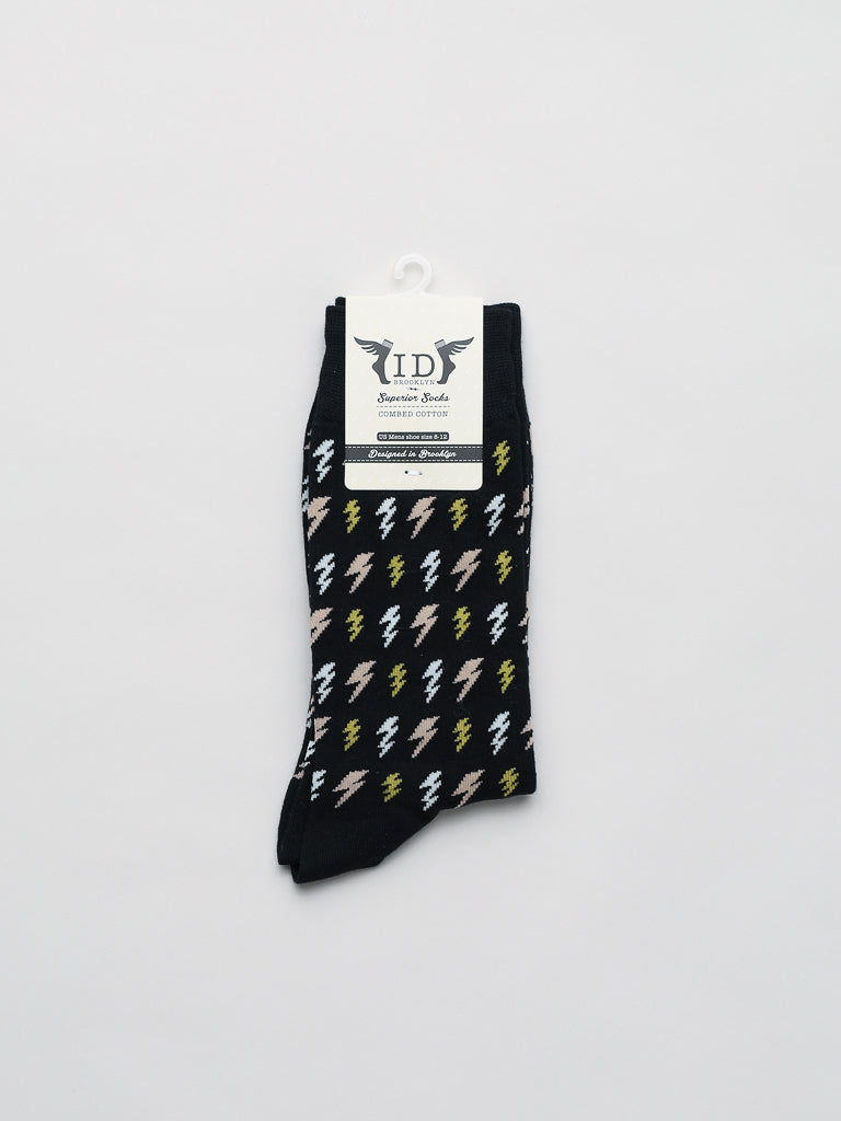 The Lightening Graphic Socks by ID Menswear are crafted from high-quality combed cotton and feature a black base with white, yellow, and gray lightning bolts. Fits mens shoe size 8-12 and comes with a branded tag against a clean white background.