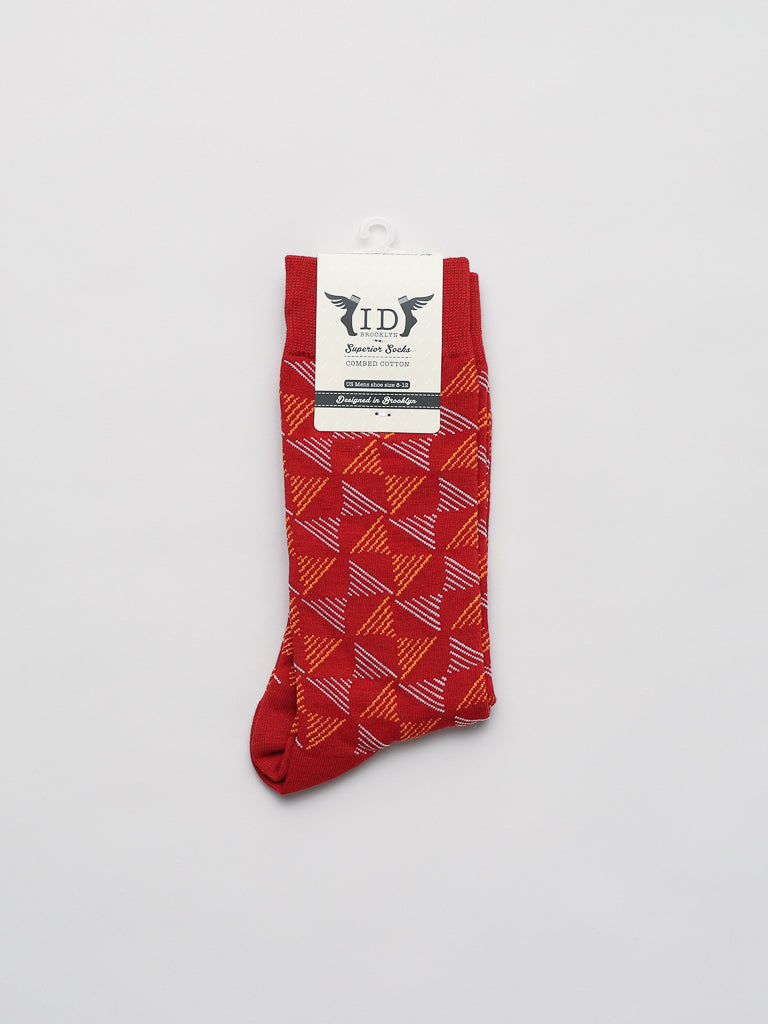 Dreamlines Graphic Socks from ID Menswear feature a geometric pattern with intersecting red and orange lines on a plain white background. Crafted from premium combed cotton, these socks promise durability while highlighting their quality and vibrant design.