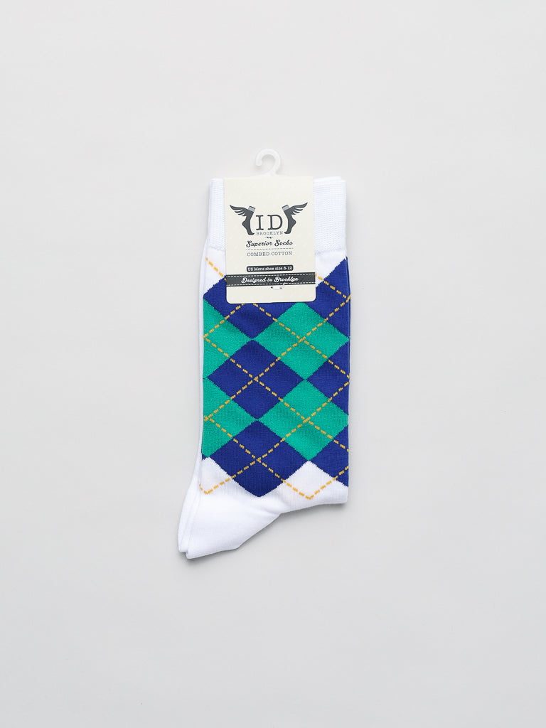 The Argyle Graphic Socks from ID Menswear feature a classic design with green and blue argyle patterns, orange diagonal stitching, and an elegantly white background. Made from soft, combed cotton, the socks include a top label showcasing the brand.