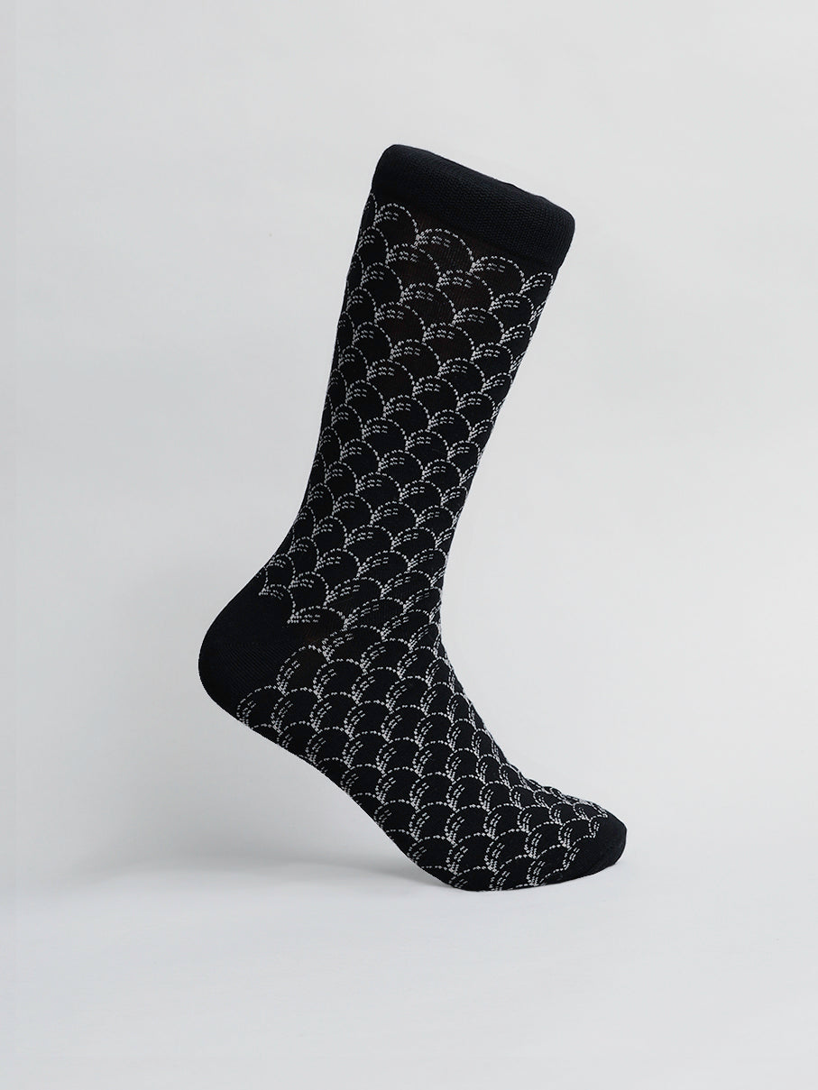 The Broken Waves Graphic Sock by ID Menswear features a black design with a white interlocking arcs pattern, set against a white background. Made from premium combed cotton, the sock provides breathable comfort and stretch for unmatched style and coziness.