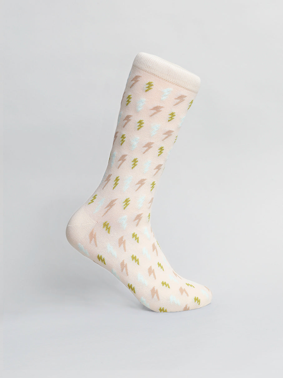 The Lightening Graphic Sock from ID Menswear features a light pink design with small brown, green, and light blue lightning bolts, a white cuff, and high-quality combed cotton. Fits mens shoe size 8-12. Displayed upright on a plain light gray background.