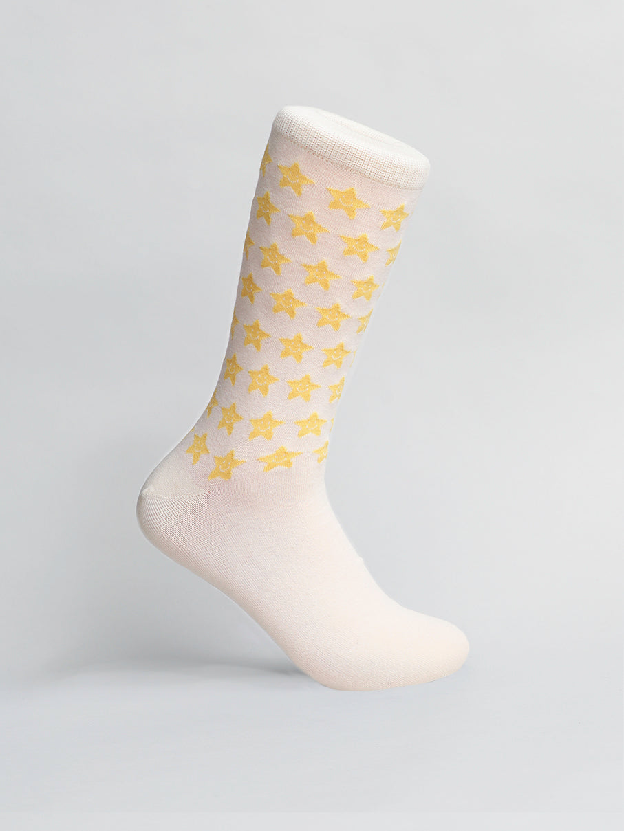 The Twinkle Graphic Socks by ID Menswear, available in cream and yellow, are crafted from soft combed cotton and set against a light gray background. Theyre a fun gift for any occasion!.