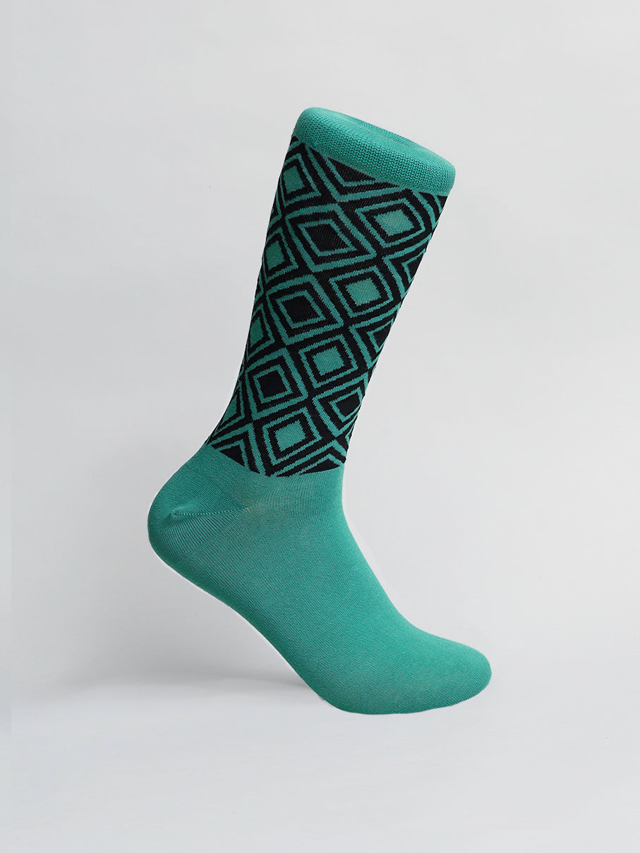 ID Menswears Diamond Graphic Socks feature a green color with a geometric black diamond pattern on the upper half, crafted from premium combed cotton against a gray background. They are available in mens shoe sizes 8-12 for the perfect fit.